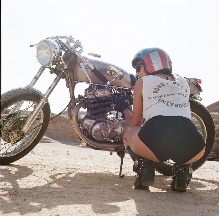 A playful frame from Girls on a motorcycle — online in New York